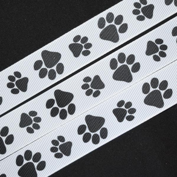 Paw prints in black printed on 7/8 white single face satin ribbon